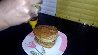 Garnish pancakes with honey as shown.