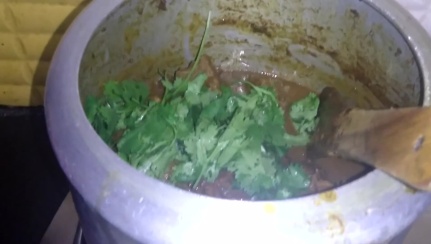 Once mutton gravy is thick add fresh coriander leaves