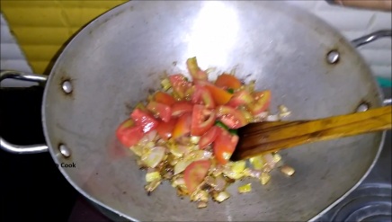Add in green chilli followed by chopped tomato